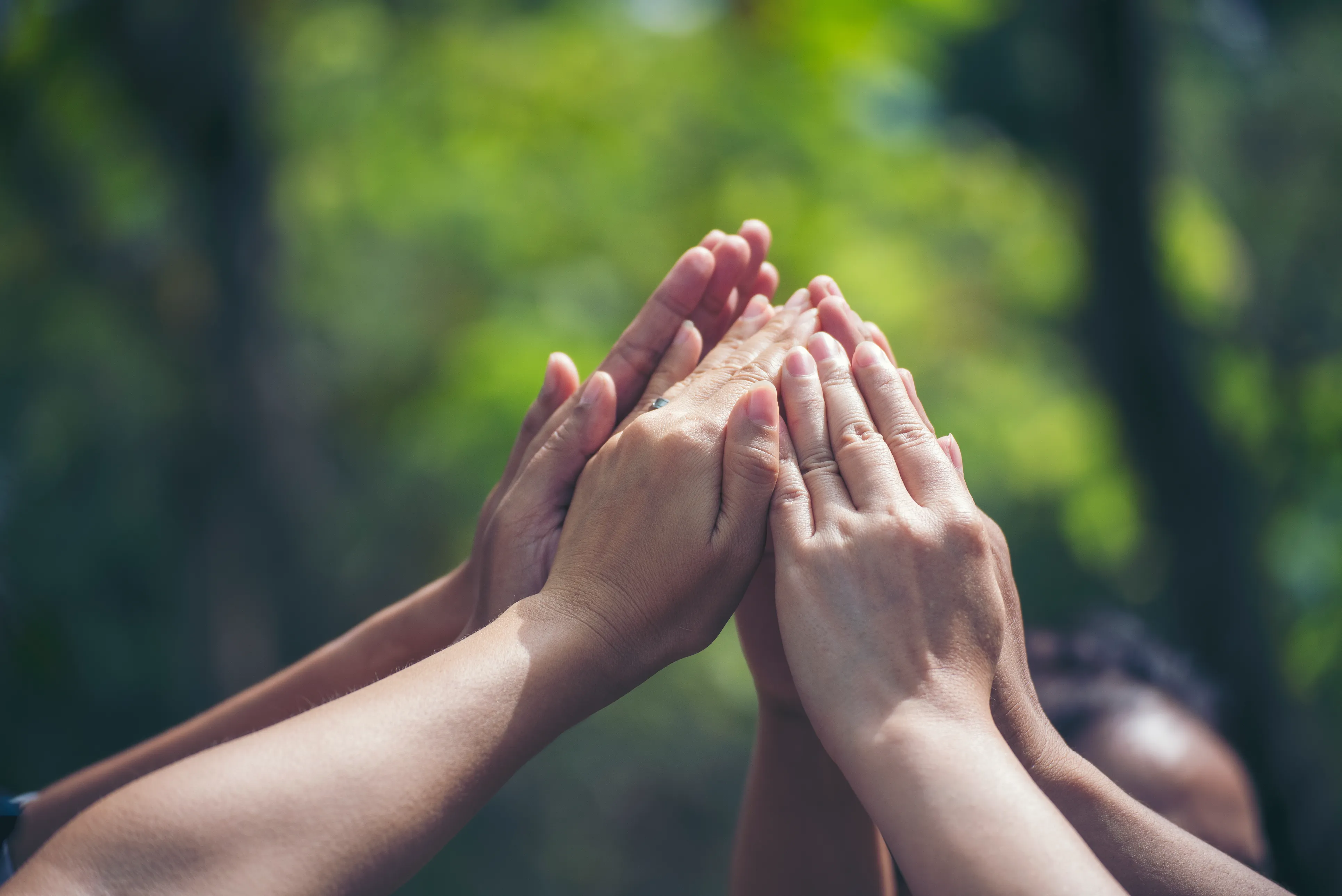 several hands clasped together